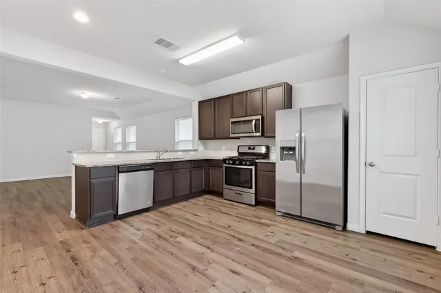 a kitchen with a refrigerator sink and microwave