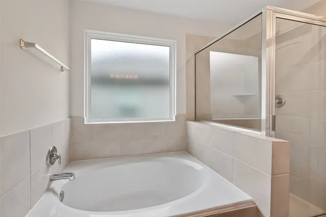 a bathroom with a tub and shower