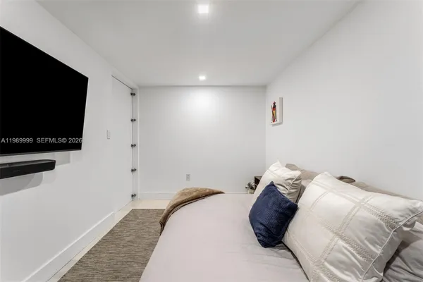 a bedroom with a bed and a flat screen tv
