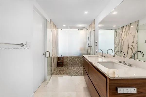 a bathroom with a sink double vanity and a mirror