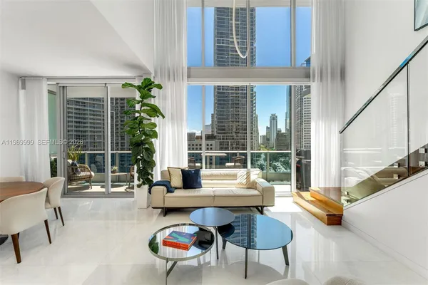 a living room with furniture and a large window