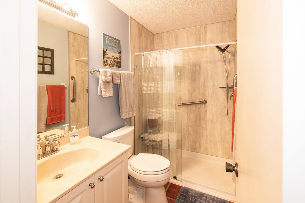 5740 Marina Drive, Unit 2 Sebastian, FL 32958 - Photo 13 of 24 a bathroom with a sink toilet and shower