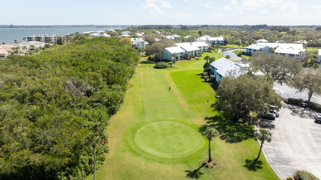 5740 Marina Drive, Unit 2 Sebastian, FL 32958 - Photo 15 of 24 a view of a swimming pool with a table and chairs