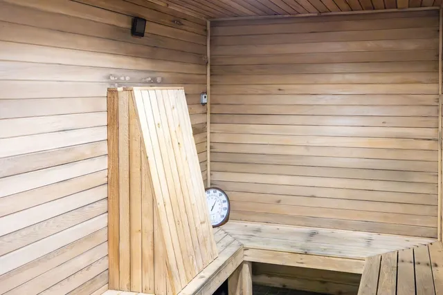 an aerial view of residential house with outdoor space and trees all around