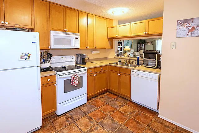 a kitchen with a sink stove and refrigerator