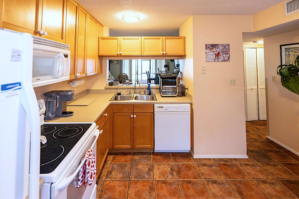 5740 Marina Drive, Unit 2 Sebastian, FL 32958 - Photo 6 of 24 a kitchen with a sink stove and refrigerator