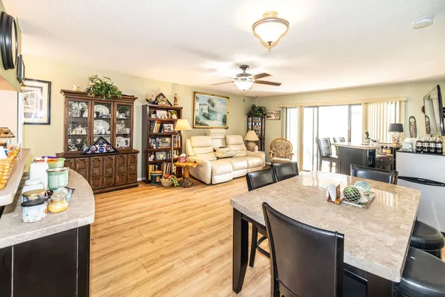 a view of a dining room with furniture and wooden floor