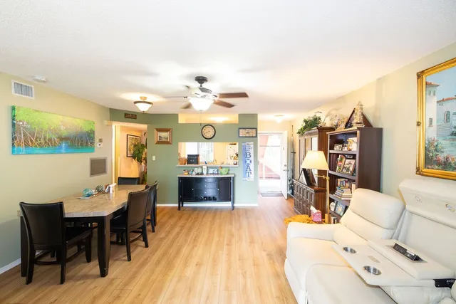 a view of a bedroom with bed and wooden floor