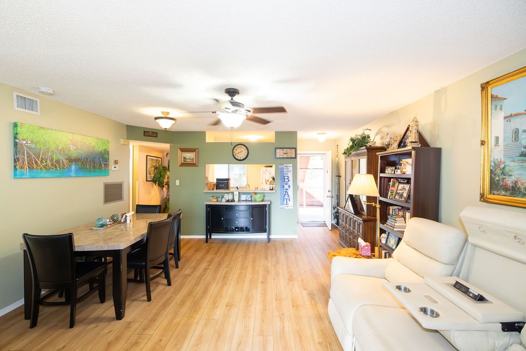5740 Marina Drive, Unit 2 Sebastian, FL 32958 - Photo 8 of 24 a view of a dining room with furniture and wooden floor