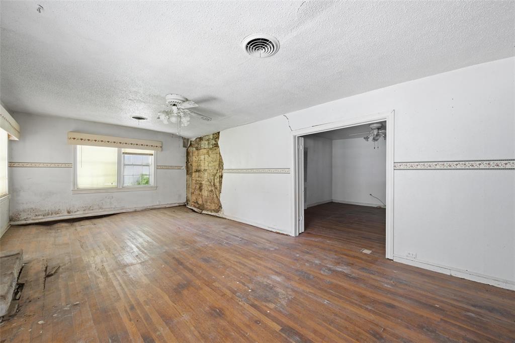 3722 North 27th Street Waco, TX 76708 - Photo 12 of 20 a view of an empty room with a window and wooden floor