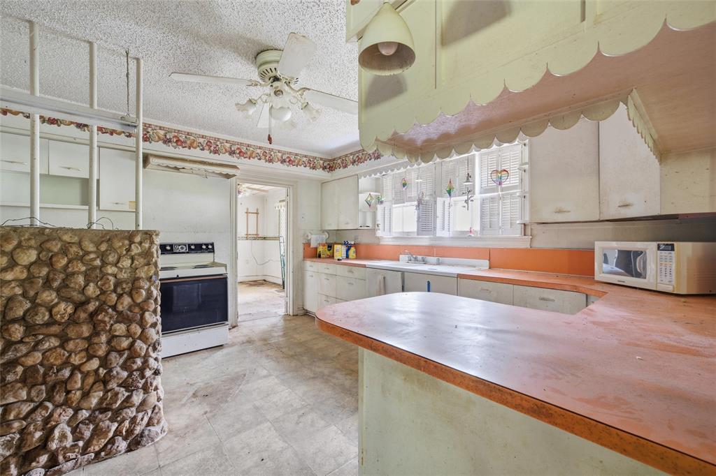 3722 North 27th Street Waco, TX 76708 - Photo 14 of 20 a large kitchen with stainless steel appliances a stove a sink and a refrigerator