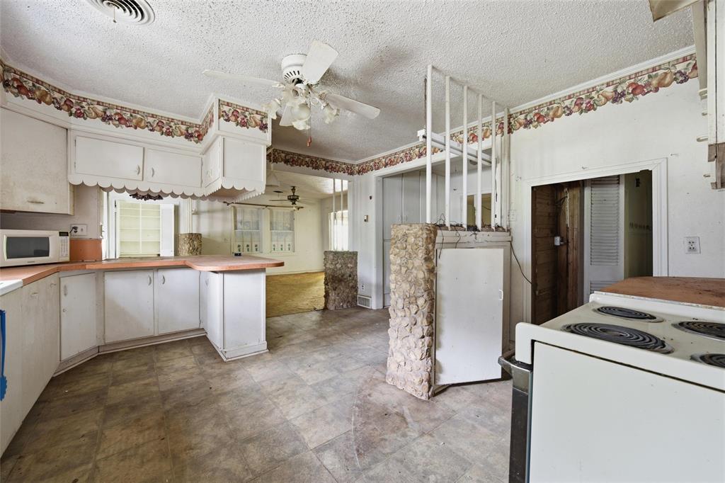 3722 North 27th Street Waco, TX 76708 - Photo 15 of 20 a view of a kitchen with refrigerator and cabinets