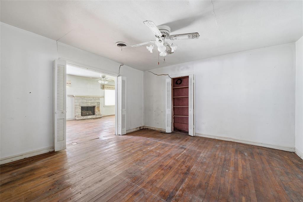 3722 North 27th Street Waco, TX 76708 - Photo 16 of 20 an empty room with wooden floor chandelier and windows