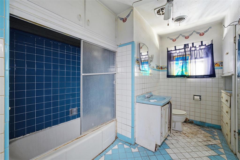 3722 North 27th Street Waco, TX 76708 - Photo 17 of 20 a bathroom with a sink a toilet a mirror and shower