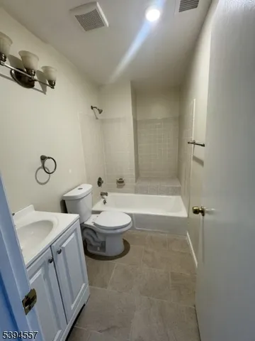 a bathroom with a double vanity sink toilet and shower