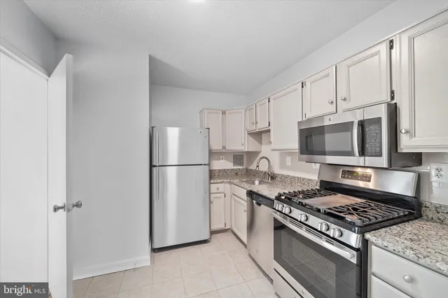 a kitchen that has a stove and a microwave