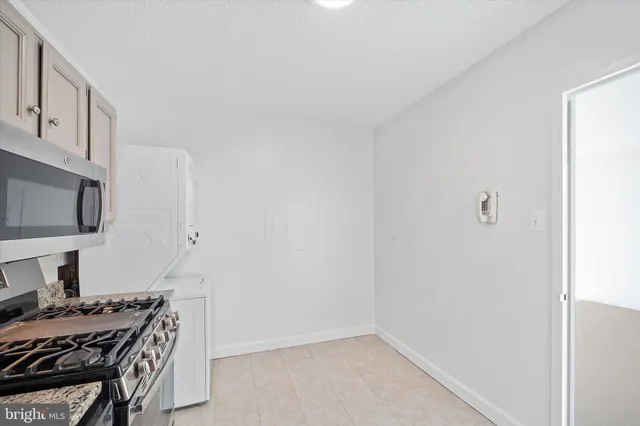 a bathroom with a toilet and a wooden floor