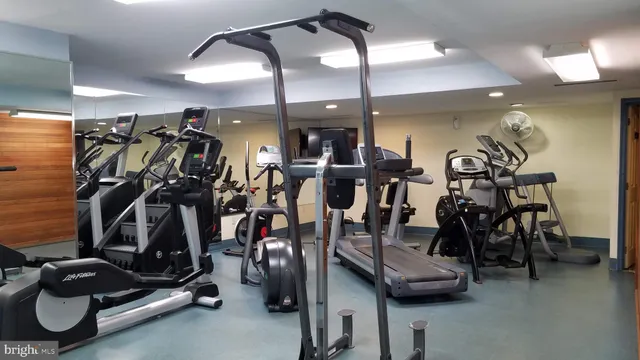 a view of a livingroom with furniture and a gym equipment