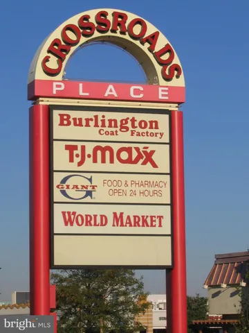 a sign that is sitting in front of flowers