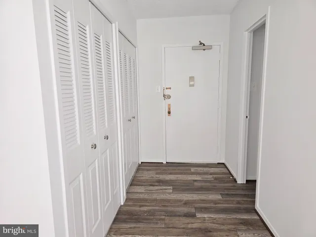 a view of a hallway with wooden floor