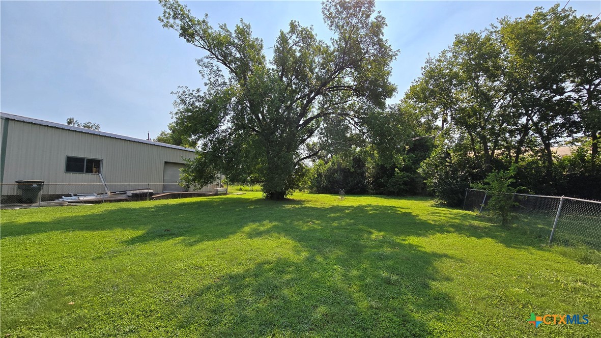 1709 South 7th Street Temple, TX 76504 - Photo 12 of 12 a view of a backyard with large trees