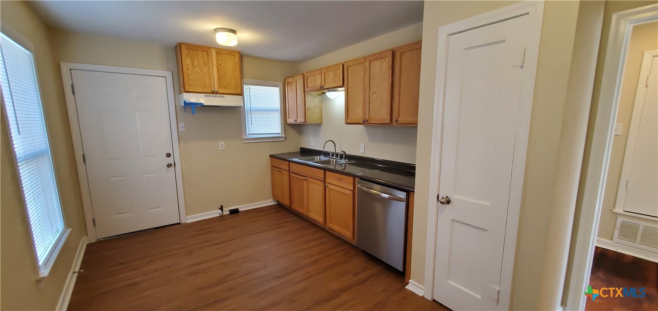 1709 South 7th Street Temple, TX 76504 - Photo 7 of 12 a kitchen with stainless steel appliances a refrigerator and a stove