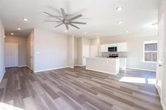a kitchen with granite countertop a sink and a stove top oven