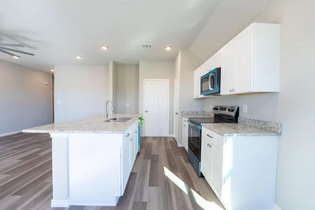 a kitchen with a sink stove and refrigerator