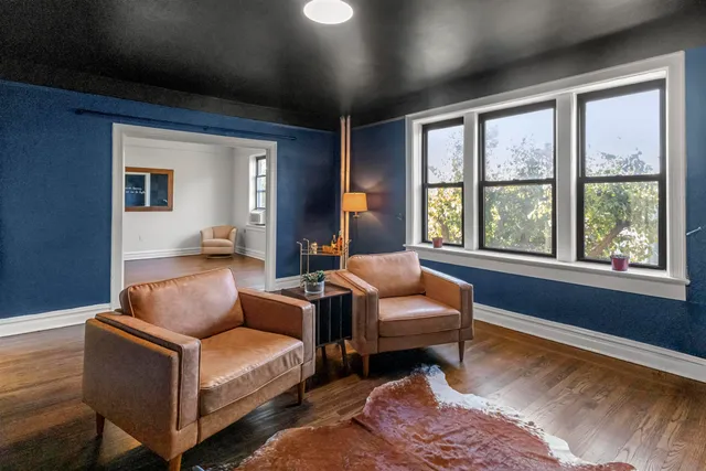 a living room with furniture and a large window