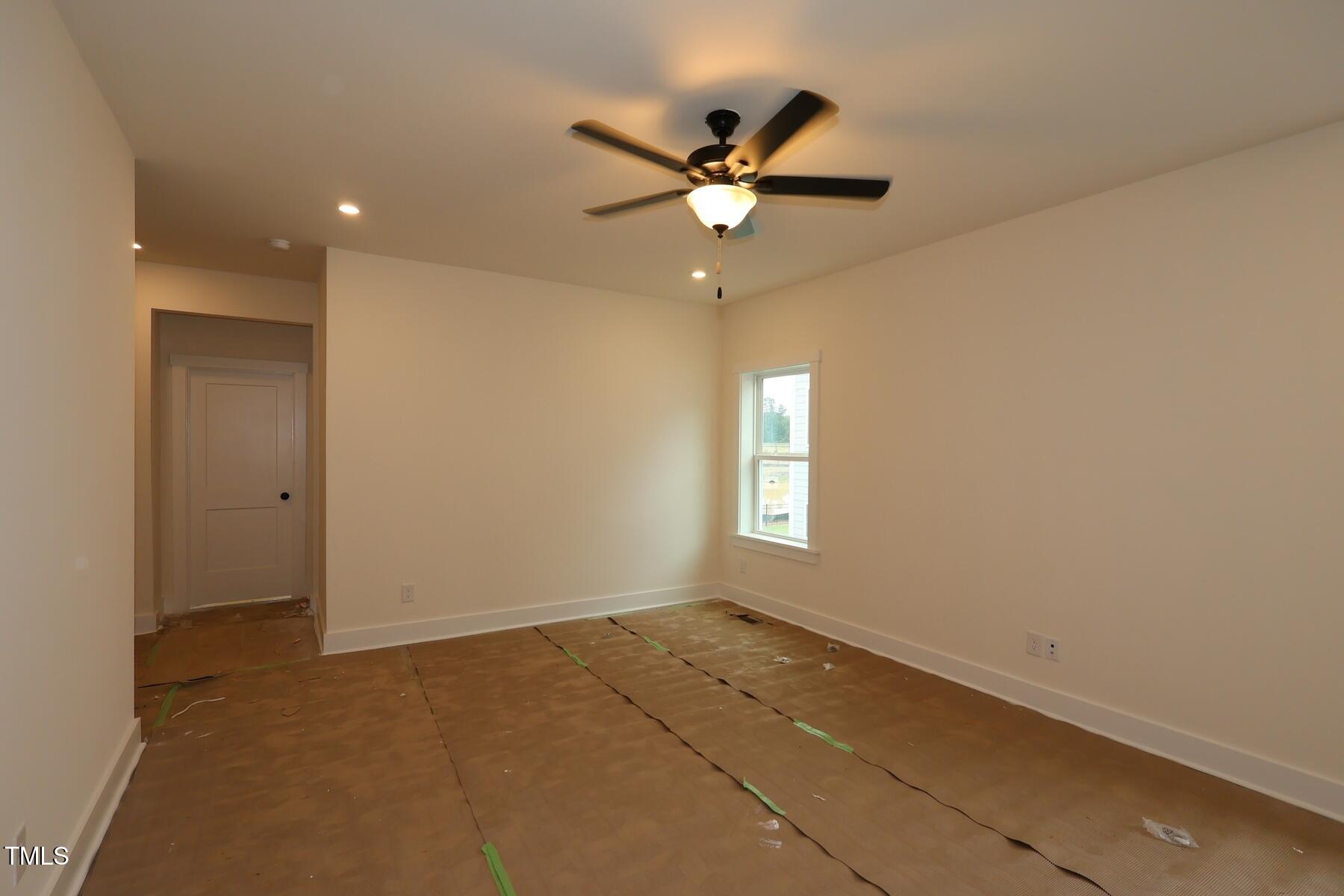 1124 Opal Lane, Unit 88 Durham, NC 27705 - Photo 16 of 27 an empty room with a window and a fan