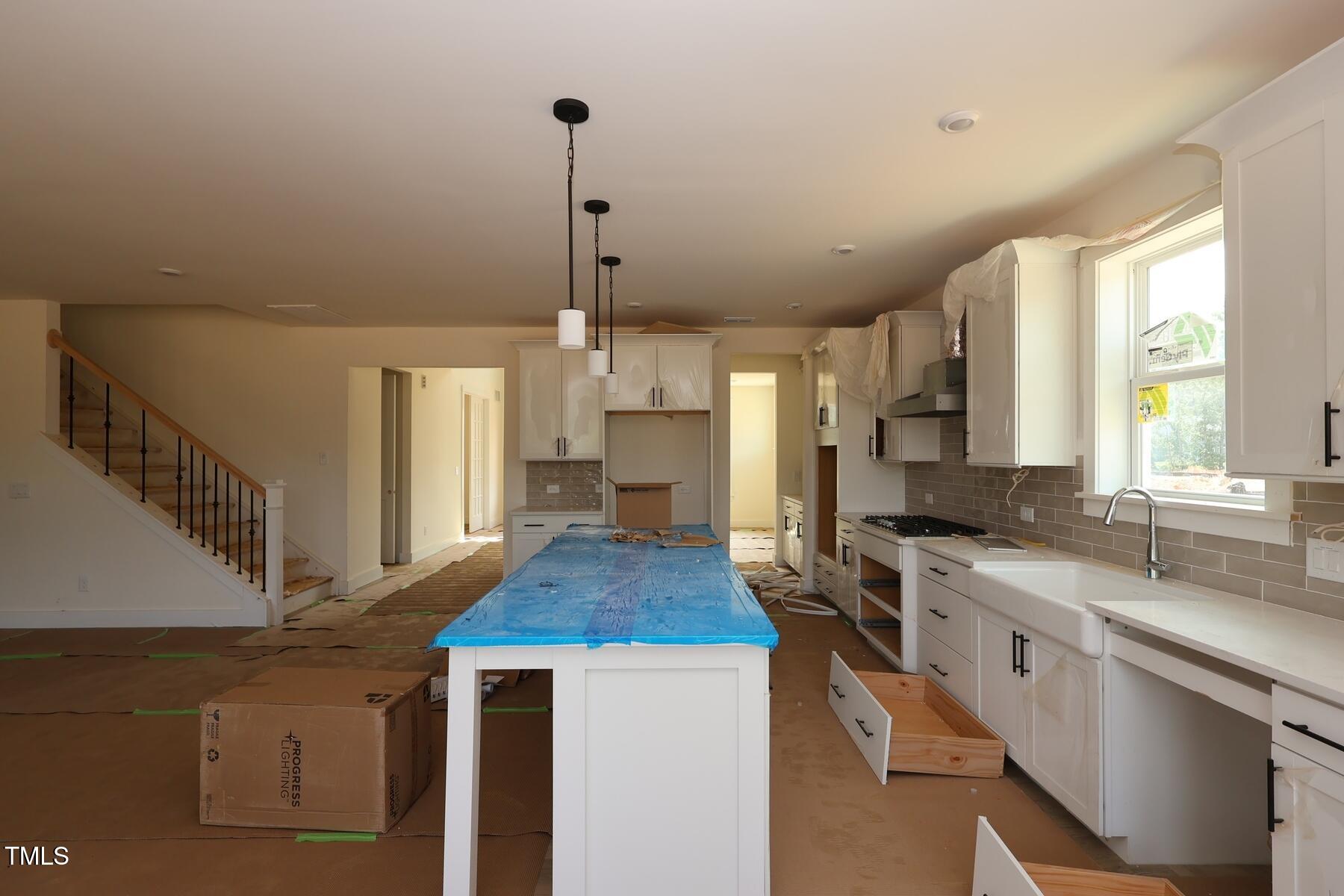 1124 Opal Lane, Unit 88 Durham, NC 27705 - Photo 10 of 27 a kitchen with stainless steel appliances granite countertop a sink a stove and a wooden floor