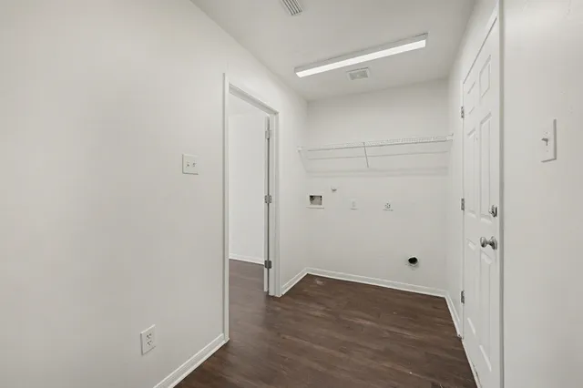 a view of a room with wooden floor