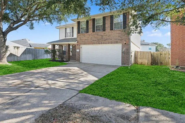 a front view of a house with a yard and a garage