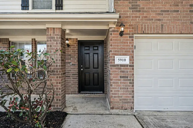 a view of front door of house with a potted plant