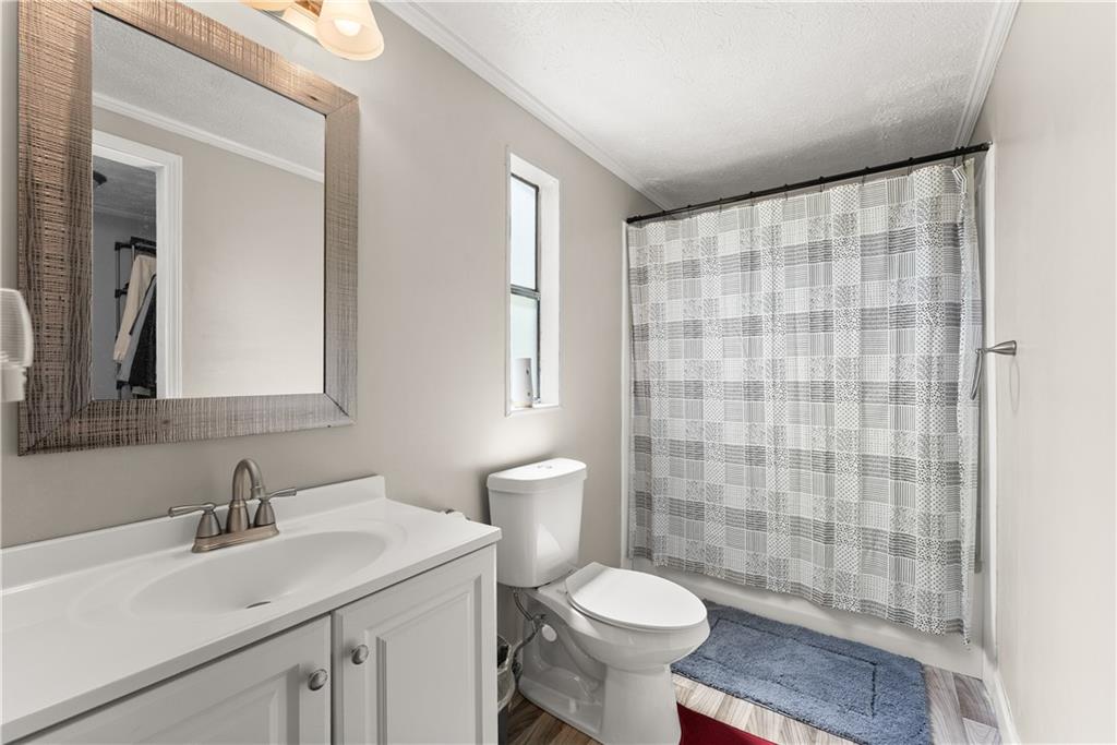 1670 Azelea Lane Gainesville, GA 30507 - Photo 14 of 33 a bathroom with a sink a toilet and shower