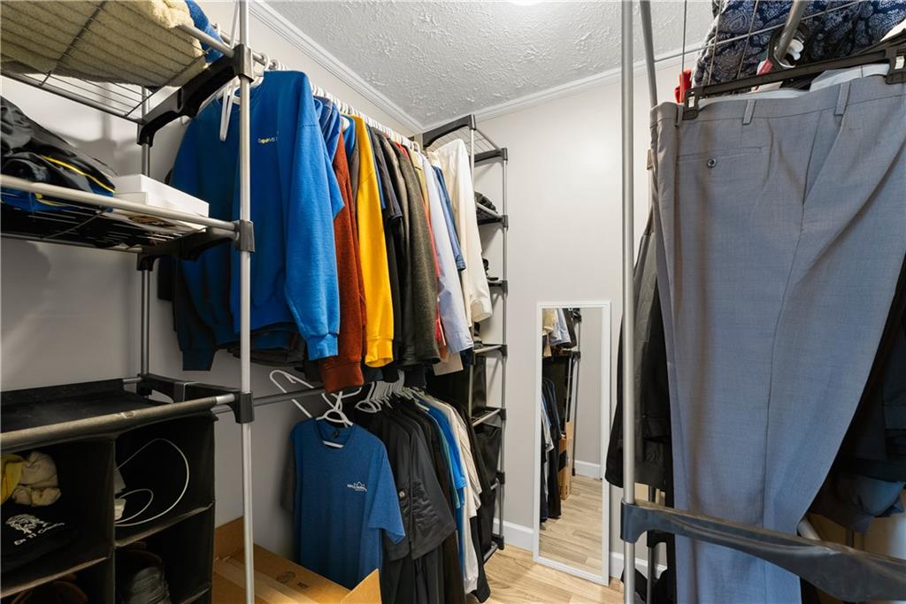 1670 Azelea Lane Gainesville, GA 30507 - Photo 15 of 33 a view of walk in closet with clothes and shoes