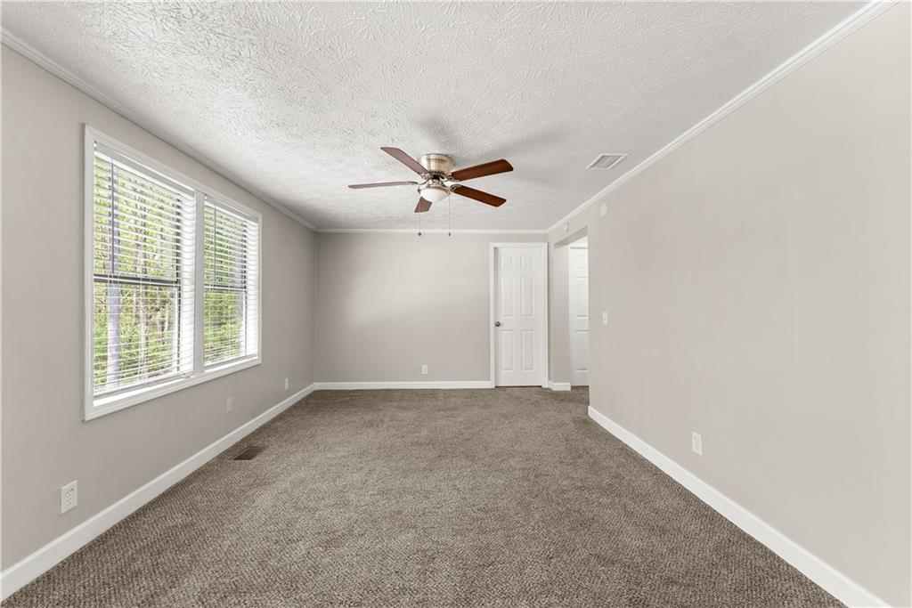 1670 Azelea Lane Gainesville, GA 30507 - Photo 16 of 33 an empty room with window and a ceiling fan