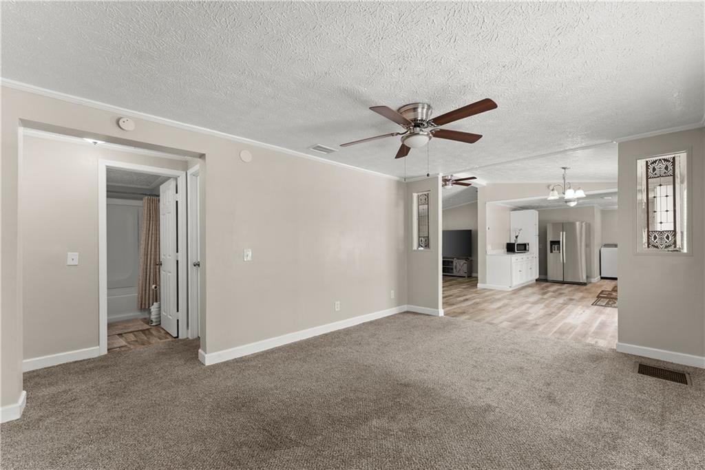 1670 Azelea Lane Gainesville, GA 30507 - Photo 17 of 33 an empty room with ceiling fan and windows