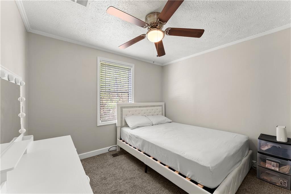 1670 Azelea Lane Gainesville, GA 30507 - Photo 19 of 33 a large bed sitting in a bedroom next to a window