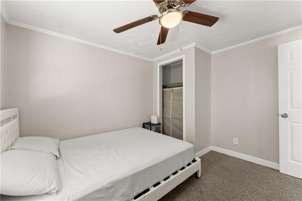 1670 Azelea Lane Gainesville, GA 30507 - Photo 20 of 33 a bedroom with a bed and a ceiling fan