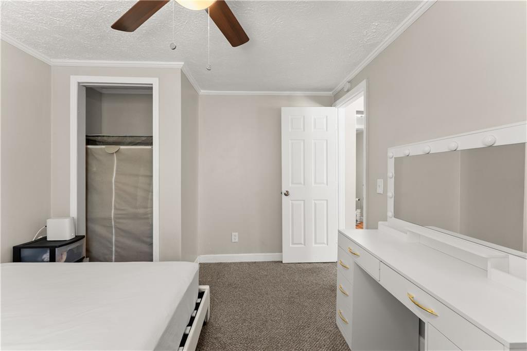 1670 Azelea Lane Gainesville, GA 30507 - Photo 21 of 33 a room with a bed and a chandelier