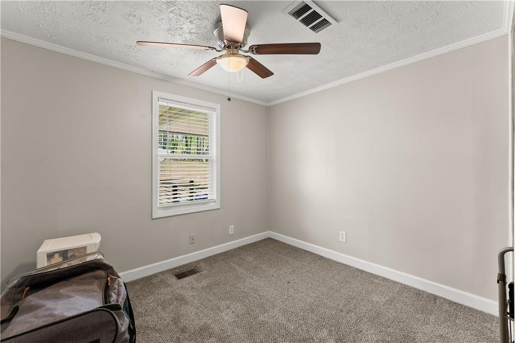 1670 Azelea Lane Gainesville, GA 30507 - Photo 22 of 33 a room with a window and a fan
