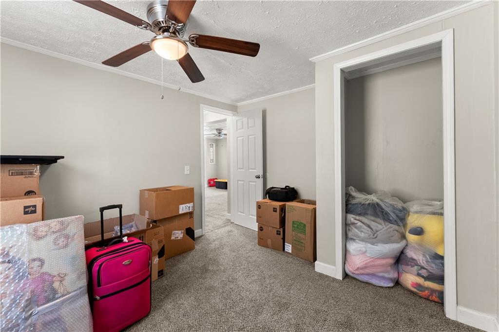 1670 Azelea Lane Gainesville, GA 30507 - Photo 25 of 33 a bedroom with a bed and a chandelier fan