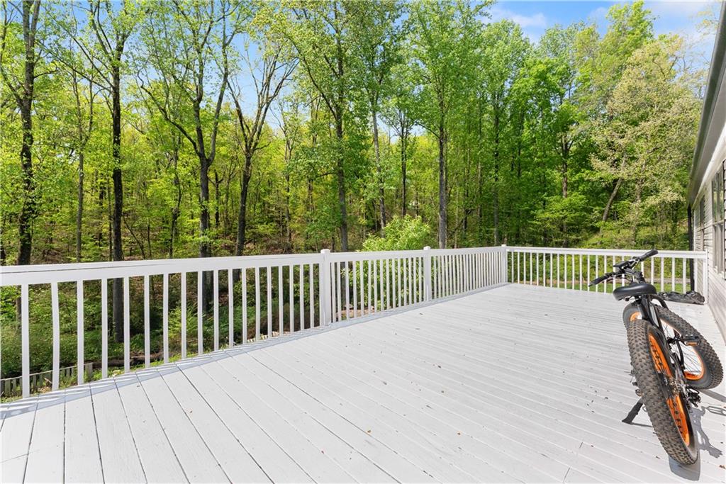 1670 Azelea Lane Gainesville, GA 30507 - Photo 26 of 33 a balcony with wooden floor and fence