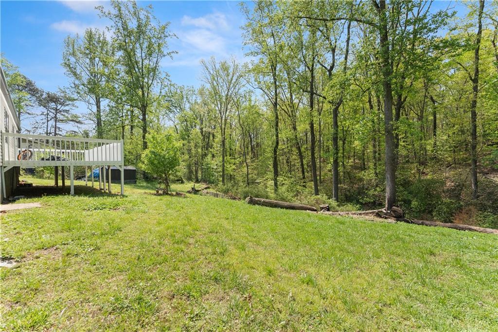 1670 Azelea Lane Gainesville, GA 30507 - Photo 27 of 33 a view of a swimming pool with lawn chairs under an umbrella