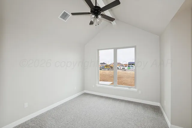 an empty room with a window and a ceiling fan