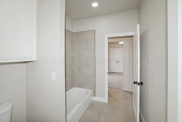 a bathroom with a tub and shower