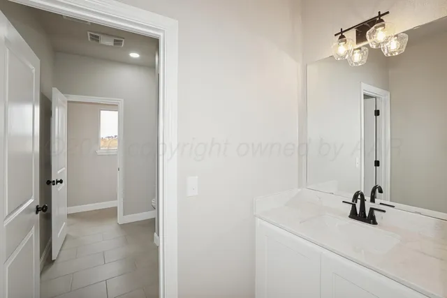 a view of a bathroom with a sink and mirror