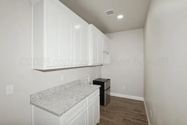 a view of empty room with white walls