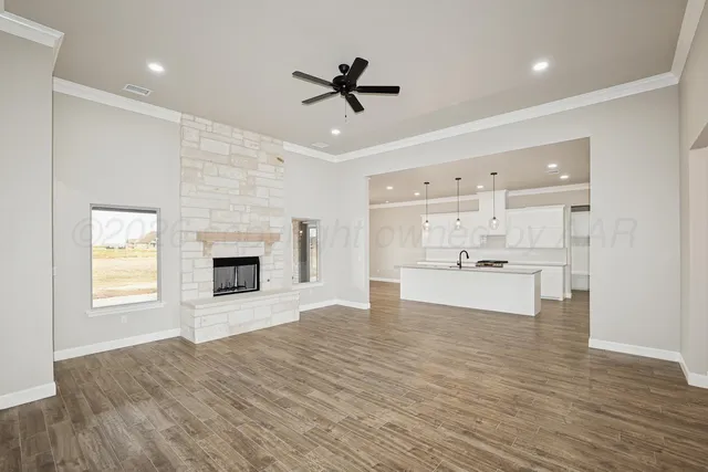 a view of kitchen with sink microwave and cabinets